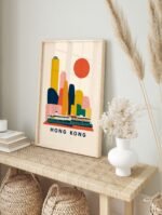 Hong Kong travel poster framed in a light wood frame, displayed on a neutral wall.