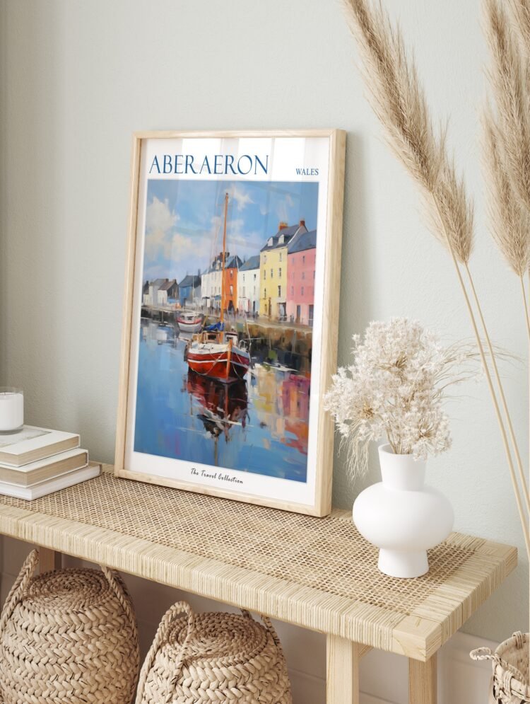 Aberaeron Wales travel poster in a simple white frame, displayed in a bright, modern living room.