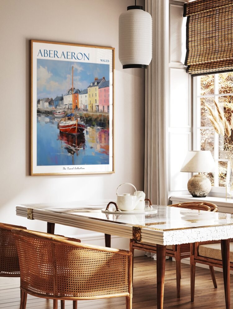 Aberaeron Wales travel poster in a black frame, hanging above a console table in a minimalist hallway.