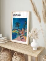Abidjan Ivory Coast travel poster in a sleek black frame, displayed on a white wall.