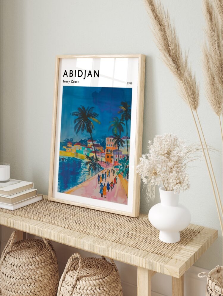 Abidjan Ivory Coast travel poster in a sleek black frame, displayed on a white wall.