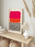 Abstract art print in a modern wooden frame, showcasing pink, orange, and black organic shapes.