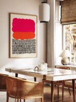 Contemporary abstract art poster with pink, orange, and black elements, displayed in a white frame.