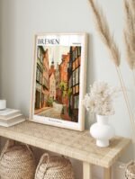 Bremen Germany travel poster in a simple black frame, displayed in a modern living room setting.