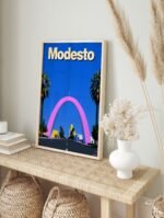 Modesto travel poster displayed in a sleek black frame, showcasing the Modesto Arch and a vibrant blue sky.
